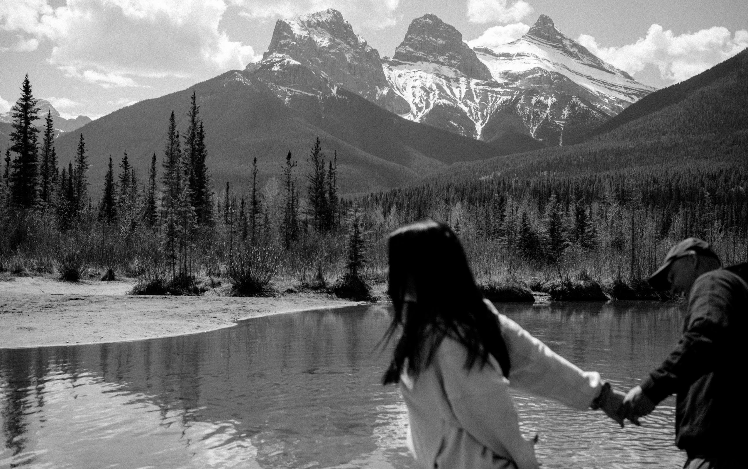 Couple by the lake at Three Sisters Viewpoint, Canmore Alberta