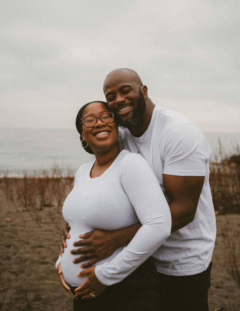 Happy couple celebrating with maternity photos