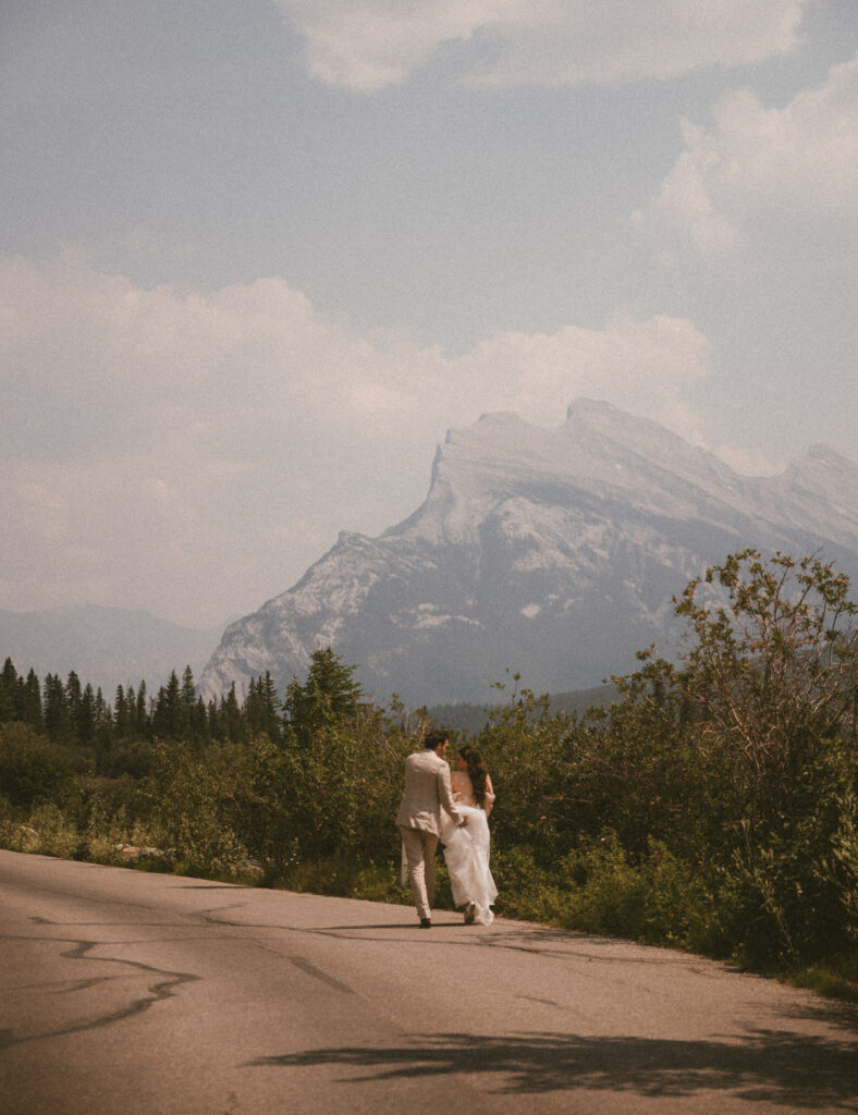Happy couple walking down the road at Vermillion Lakes