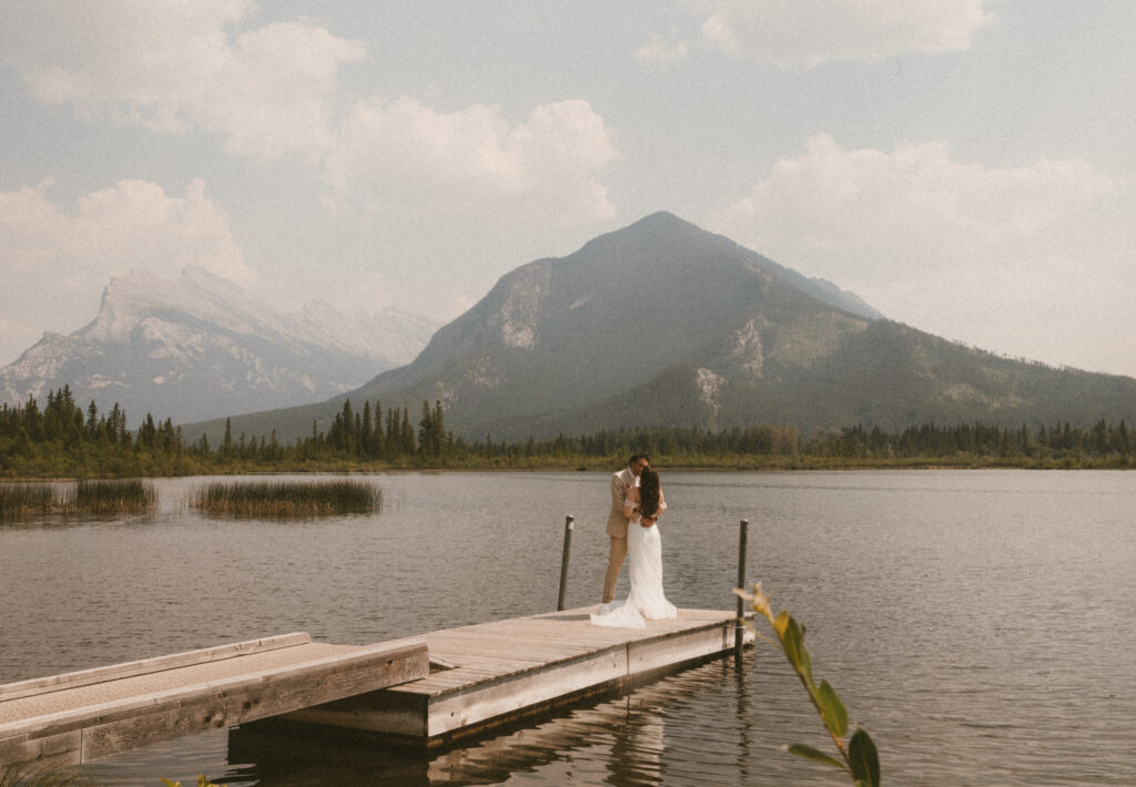 Kissing on the docks of Vermillion Lakes in Banff Alberta
