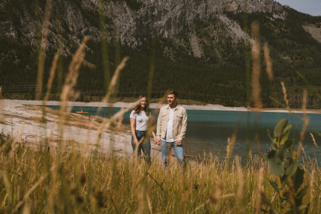 Couple strolling together in nature at Barrier Lake in Kananaskis Alberta